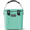 imageYETI Roadie 24 20 Hard Cooler with DoubleDuty Shoulder Strap and Drain PlugSeafoam